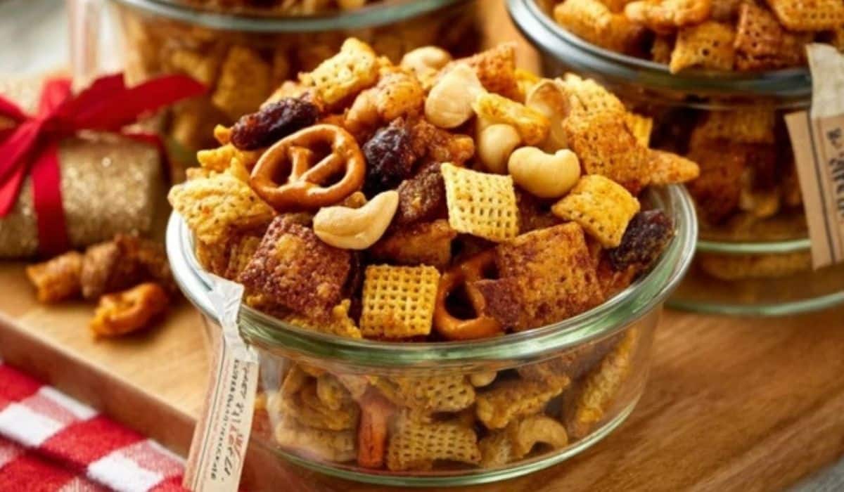 Party Snack Mix in rustic bowl on wooden table