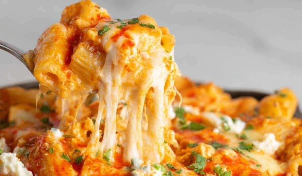 Buffalo Chicken Mac and Cheese in a bowl with melted cheese and buffalo drizzle