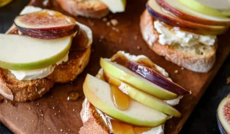 Brie, Apple, and Fig Crostini appetizer on rustic board