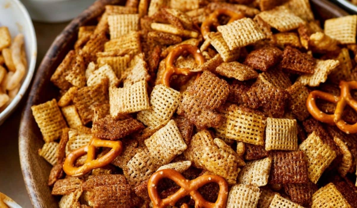 The Best Extra Bold Savory Chex Mix in a rustic wooden bowl