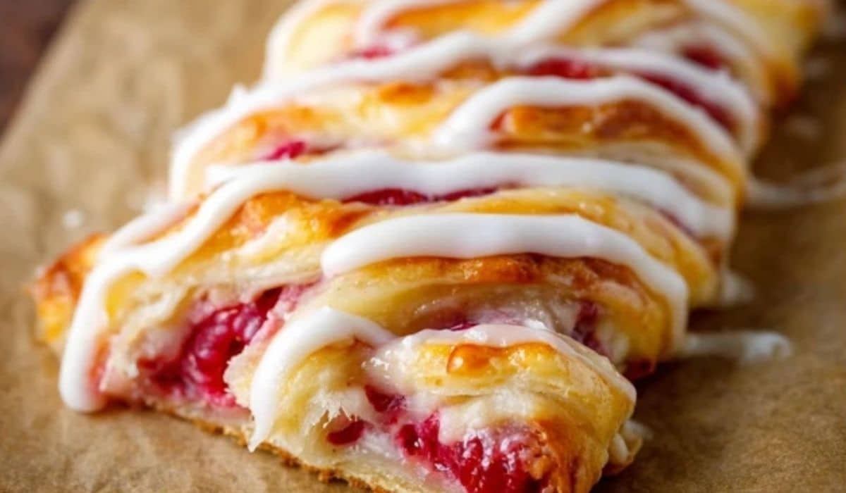 Iced Raspberry Pastry Braid on rustic wooden table