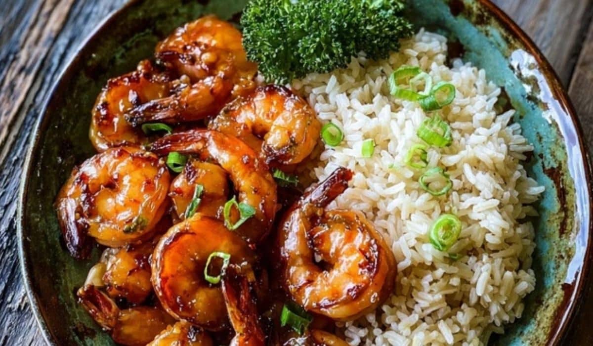 Honey garlic shrimp with rice on wooden table