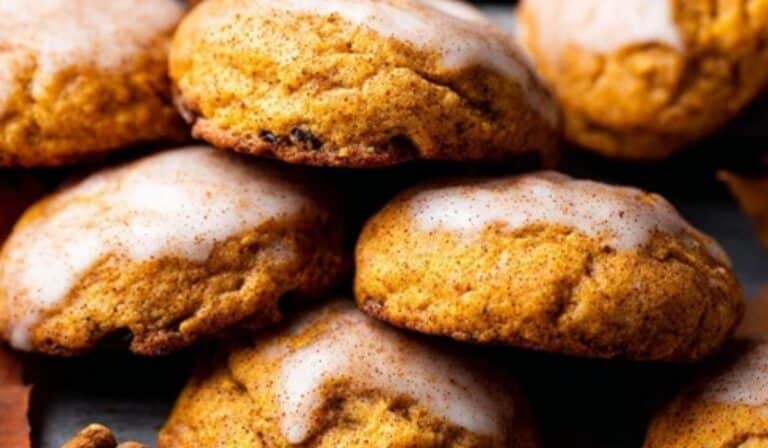 Soft Pumpkin Cookies stacked with autumn leaves