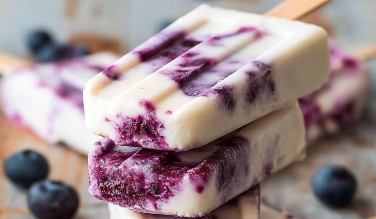 Blueberry Yogurt Swirl Popsicles on rustic table