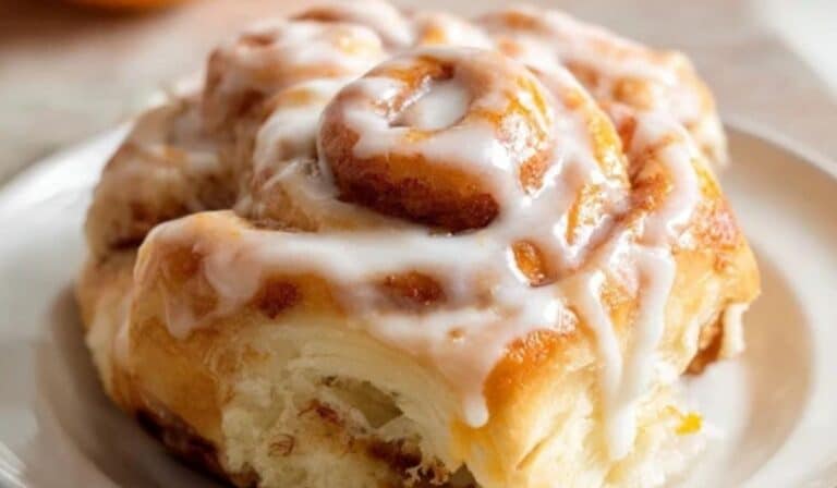 Homemade Orange Sweet Rolls stacked with orange glaze