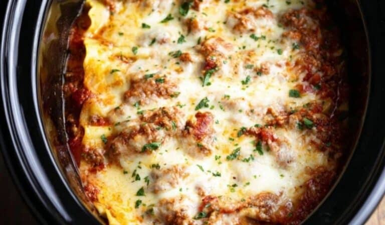 Easy Crockpot Lasagna Recipe sliced in a slow cooker with melted cheese