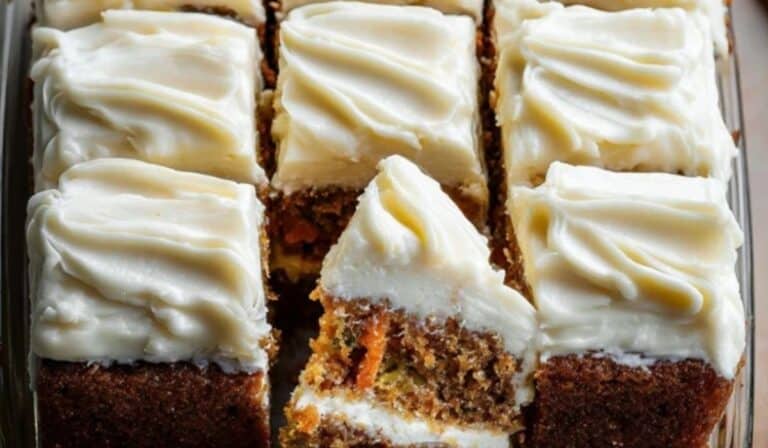 Pineapple Carrot Cake with Cream Cheese Frosting sliced on rustic table