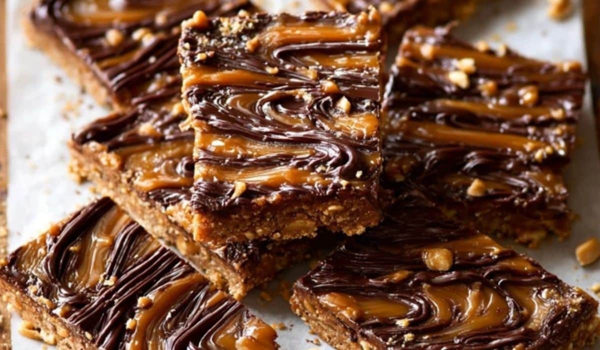 Chocolate Peanut Butter Snack Bars stacked with gooey layers