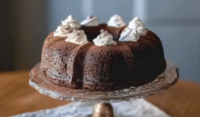 Chocolate Guinness Bundt Cake with Whiskey Whipped Cream on a cake stand