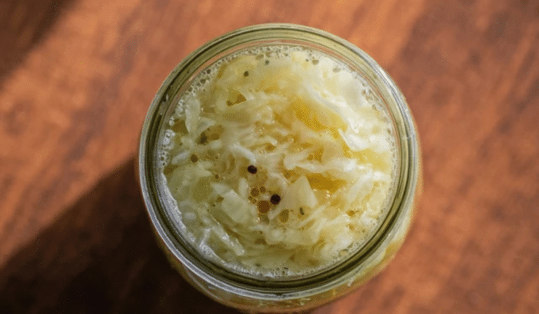 Fermented Cabbage (Sauerkraut) in a mason jar with brine and bubbles