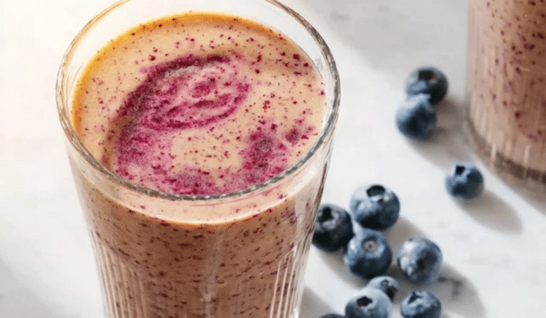 Mixed-Berry Breakfast Smoothie in a glass with berry swirl topping