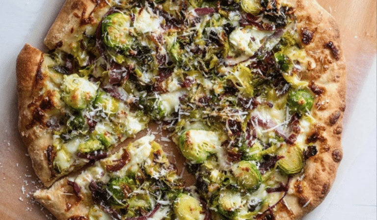 Brussels Sprouts Pizza with caramelized onions and melty mozzarella on a wooden board