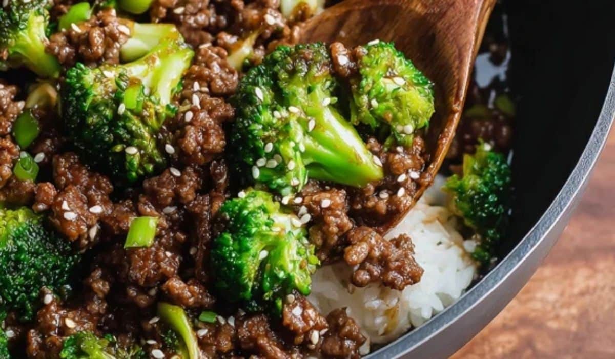 Ground Beef and Broccoli in a skillet with glossy sauce and sesame seeds