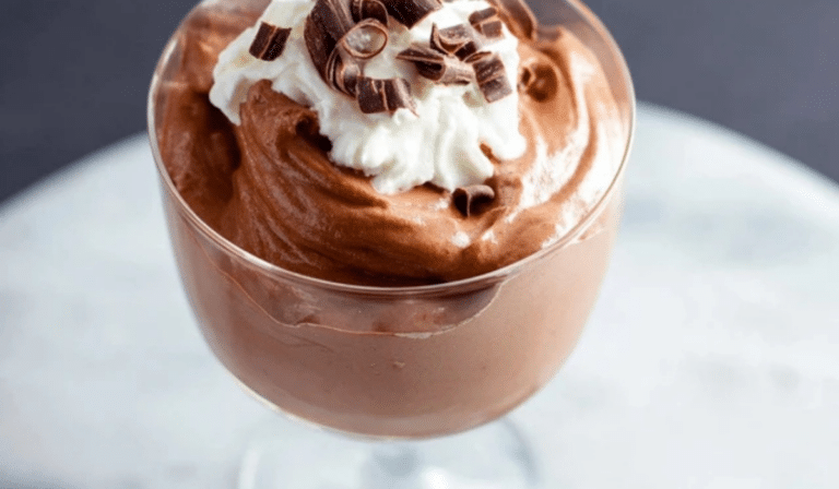 Easy Chocolate Mousse in a glass topped with whipped cream and chocolate curls