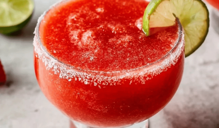 Frozen Strawberry Margarita in a salt-rimmed glass with lime